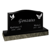 Black headstone with curved top and engraving of birds